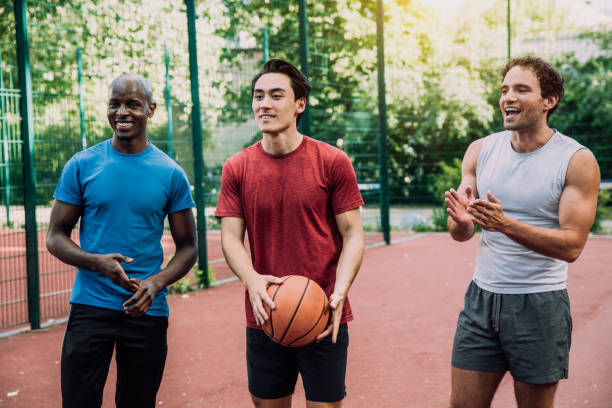 istock friends playing Basketball 1225997691