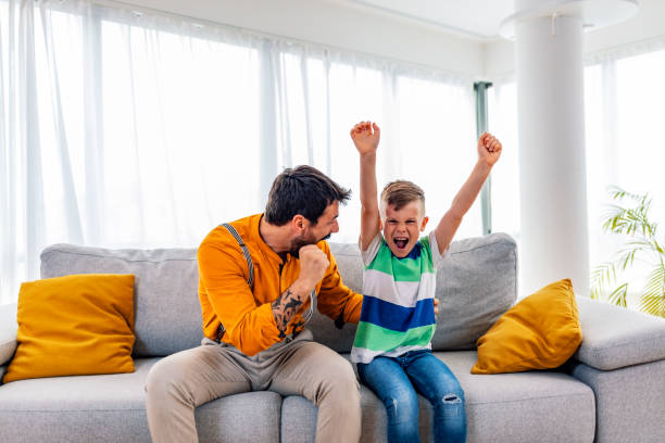 istock Boy watching soccer match with father 1225999162