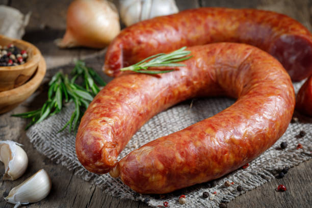 istock Smoked sausage on a wooden table. 1226003221