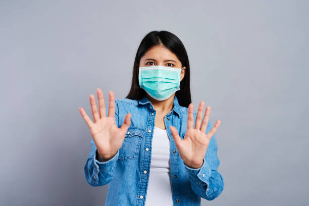 istock Frightened Asian woman in surgical mask 1226003283