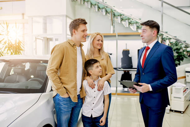 istock young beautiful couple with child choosing their first auto 1226003450