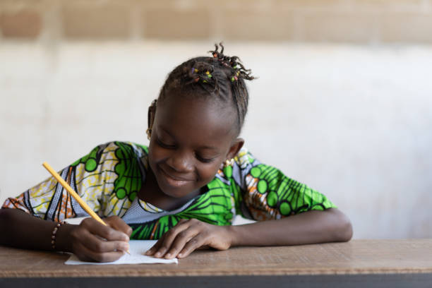 istock Adorable Black Ethnicity Child Writing Pencil Paper School 1226003497