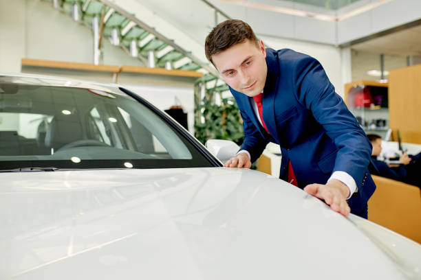 istock handsome businessman checking, examining new car before making purchase 1226003530