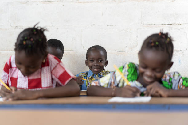 istock Classroom Full of African Students Smiling and Working in School 1226004229