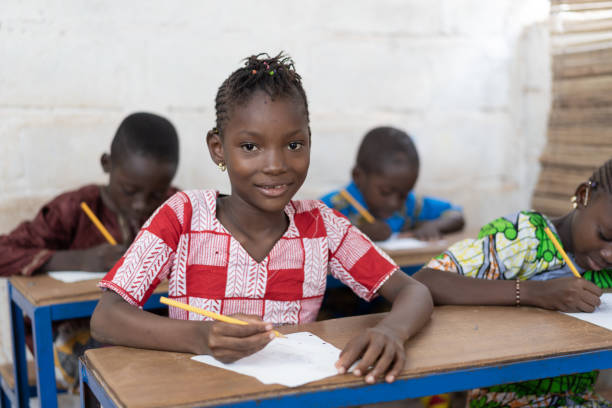 istock Cute African Ethnicity Girl In Classroom looking at camera. 1226004597