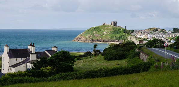 Criccieth, North Wales, UK: Jun 3, 2017: A scenic view of Criccieth Castle which sits on  a headland beside the sea.