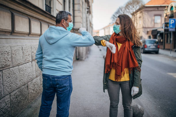 istock Two people greeting each other with elbows instead of handshake 1226004955