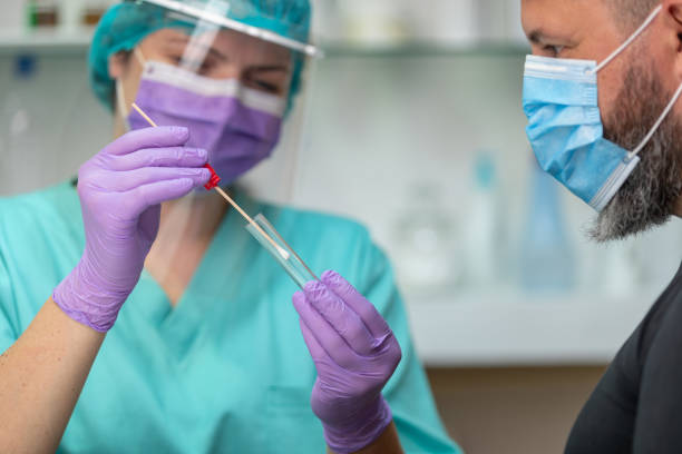 istock Female doctor wearing protective workwear preparing swab for sampling 1226004975