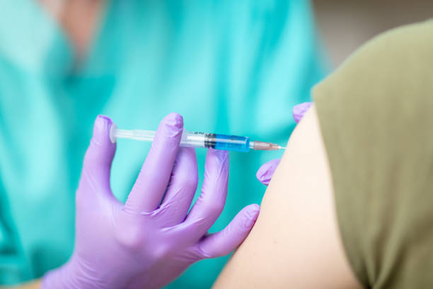 istock Injecting vaccine in patient's arm 1226006165