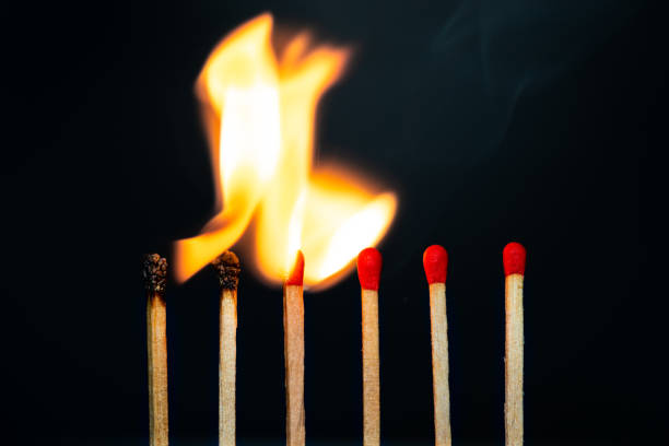 istock Group match burning on a black background detail art 1226006953