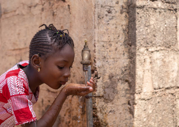 istock Access to Water is a Human Right, cute African drinking freshwater 1226008851