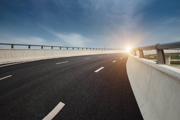 istock Clear blue sky and white clouds in the background, highway overpass curved approach bridge 1226009383