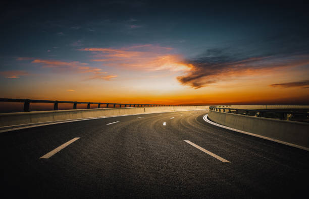 istock Dusk colored clouds in the background, highway overpass curved approach bridge 1226009585
