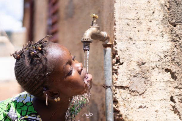 istock Joyful Black Child Drinks Fresh Water from a Tap 1226009601