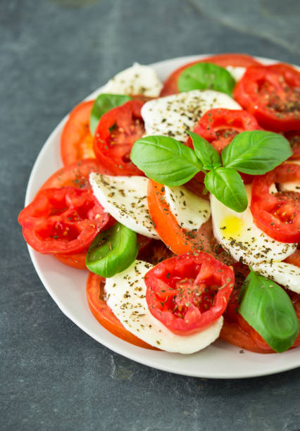 istock Fresh caprese salad with mozzarella, tomato, basil and spices on the plate 1226011246