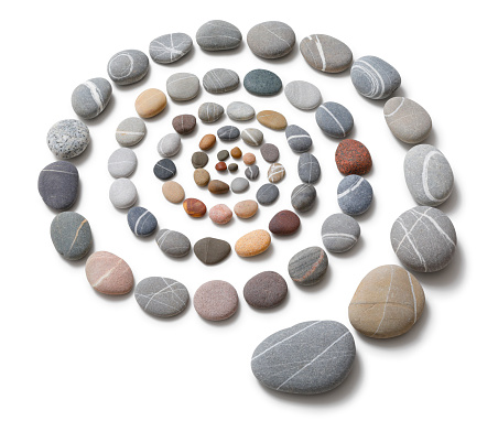 Arranged pebbles isolated on white with clipping path and natural shadows