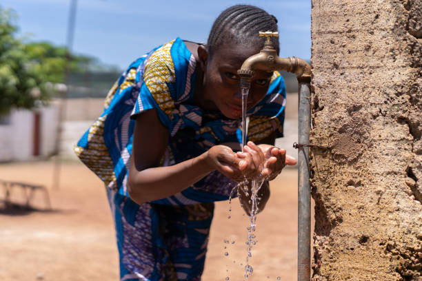 istock Tasting Fresh Water, African Black Child Enjoys Freshwater 1226011706