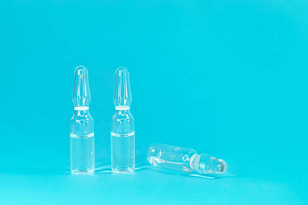 istock Ampoule on a blue background with close-up. COVID-2019 1226012031