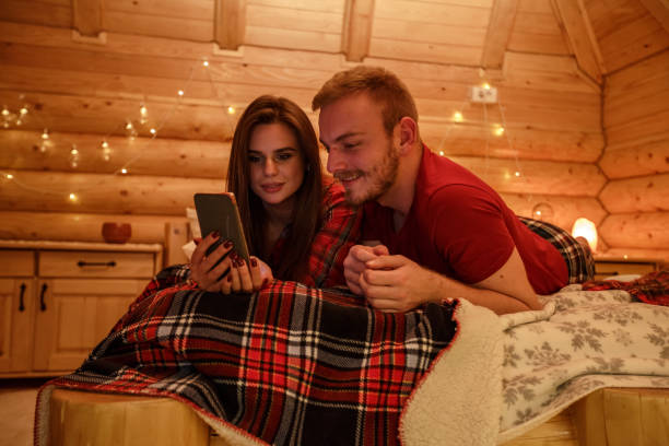 istock Young couple watching videos on a smart phone in bed 1226018019