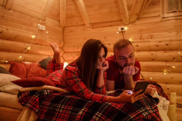 istock Couple in bed watching videos on smart phone 1226018021