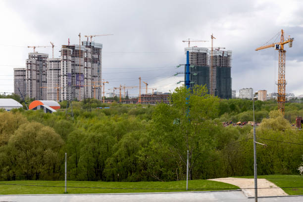 View of several construction sites with construction cranes working on the construction of residential complexes stock photo
