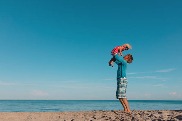 istock father and little daughter play at sky on beach 1226019875