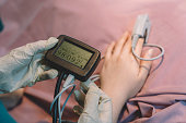 nurse examining pulse oximeter readings of a patient at hospital operating room