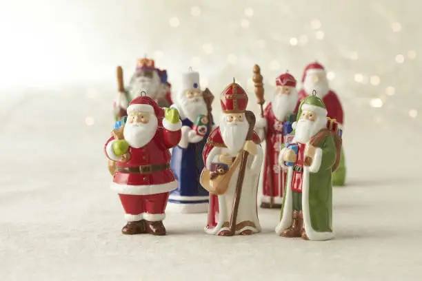 Photo of Ceramic Santas Figurines, Porcelain festive statuettes, group of Festive decorations.Collection of Vintage Santas.