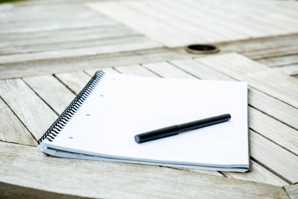 istock Writing pad and pen on a garden table 1226025638