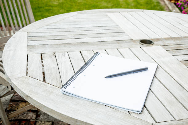 istock Writing pad and pen on a garden table 1226025745
