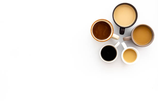 istock Different cups of coffee on white table top-down space for text 1226027551