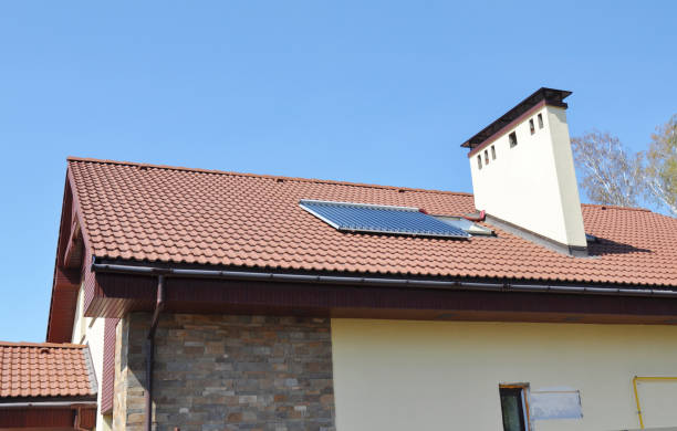 istock Solar water heater on a modern house rooftop with skylight, gutter and chimney. 1226028572