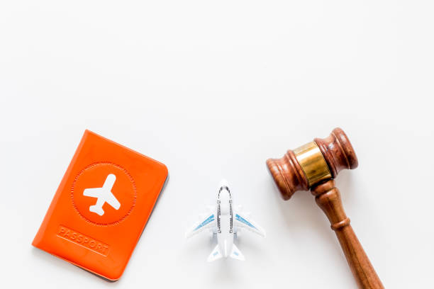 istock Flight cancellation. Airplane, passport, judge gavel on white desk top-down copy space 1226028806