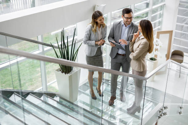 istock Young business people discussing ideas over digital tablet on staircase 1226029103