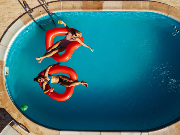 istock Young women relaxing in a swimming pool 1226032688