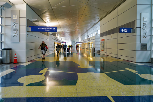 Passengers are walking in the terminal of Sydney Airport, Australia.