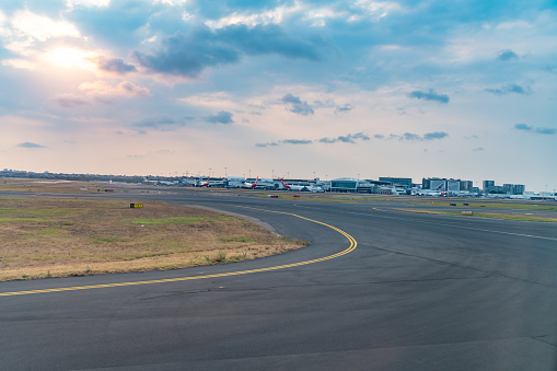 Sydney International Airport runway at dusk, New South Wales, Australia.