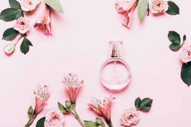 istock Women's perfume bottle and roses flowers on pink background. Creative Layout, copy space 1226038105