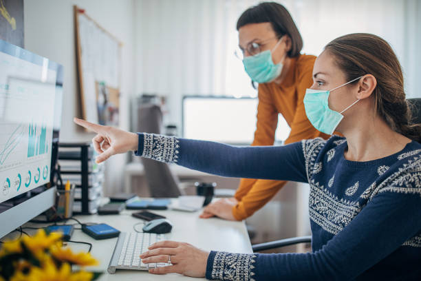 istock Two women working in office with protective masks, to protect themselves against coronavirus 1226038924