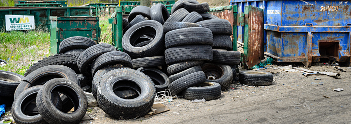 Brockville, Ontario, Canada - May 19, 2020: Panorama of vehicle tires and dumpsters at a waste facility