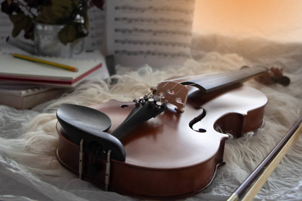 istock Close up Violin put in front of blurred sheet note,on grunge surface background,prepare for practice,blurry light around 1226039284