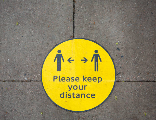 istock COVID19 Social Distancing Signage on pavement 1226039811