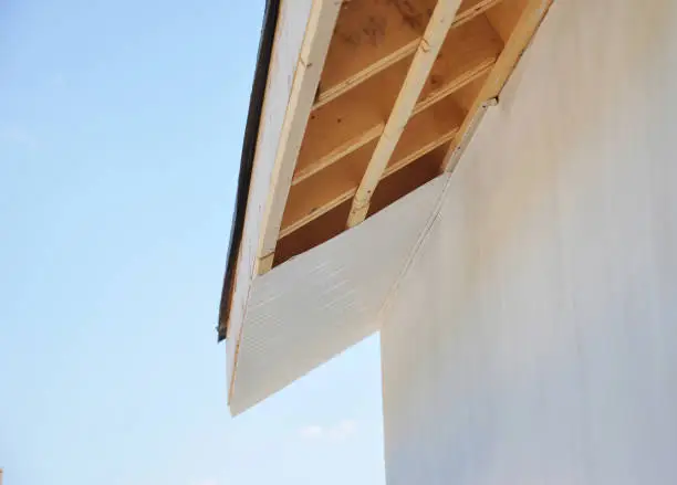 Photo of Installig eaves, soffit boards, fascias on new house roofing construction