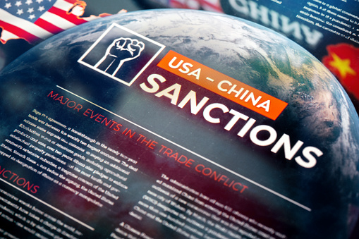 USA vs China Sanctions. Global Financial Trade War on World Map Background