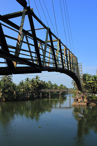 A metal foot bridge across the backwaters in Alleppey, Kerala