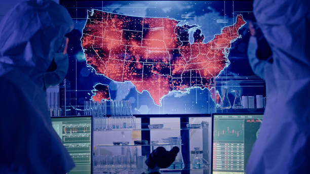 istock Scientists looking at screen with large USA outbreaks. Futuristic Research Laboratory 1226044044