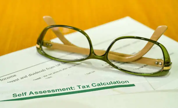 Photo of Close up of a tax assessment notice with a pair of reading glasses. No people.