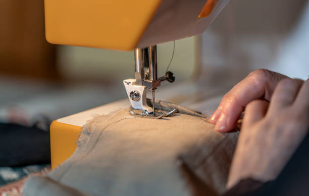 istock woman making and cutting for machine sewing garments 1226045703