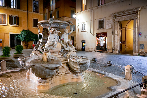 Rome, Italy, January 07 -- A beautiful night view of Piazza Mattei in the heart of the Jewish Ghetto of Rome, with the famous Fontana delle Tartarughe, a Renaissance fountain with bronze figures of young people, turtles and dolphins, attributed to the architect Giacomo della Porta and built in 1581. Image in HD format.