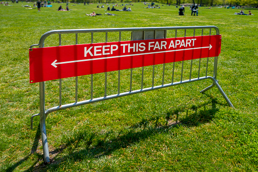 park lawn entrance message of social distancing 